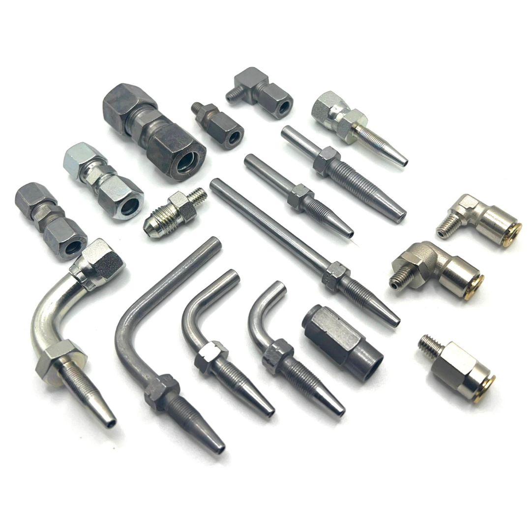 Collection of 4mm grease fittings and nylon tubes, including compression fittings, hose studs, and push-in fittings, designed for precise and compact lubrication applications in industrial settings